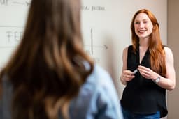 Business owner presenting at whiteboard
